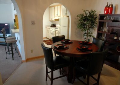 A dining room featuring a wooden table surrounded by elegant chairs, creating a warm and inviting atmosphere.